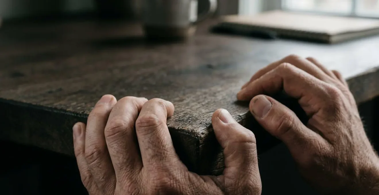 Macro detail of worn hands gripping a surface suggesting fatigue and overextension