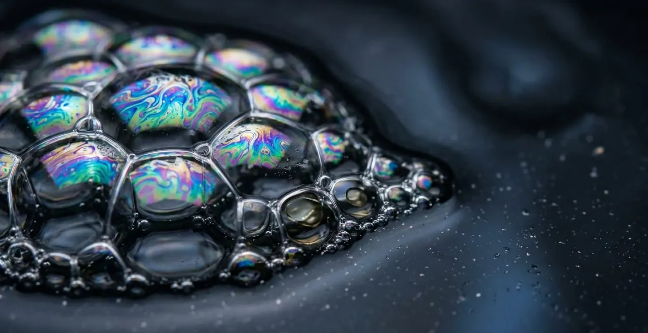 An abstract, macro view of a healthy cell membrane, showing fluid, iridescent structures that represent the integration of omega-3s, allowing for better neurotransmitter function.
