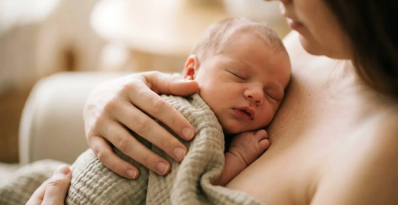 Partner holding newborn in skin-to-skin contact creating bonding moment