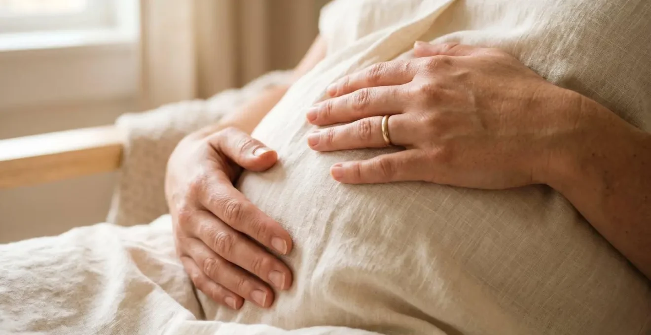 Close-up of pregnant woman's hands gently resting on belly during meditation practice